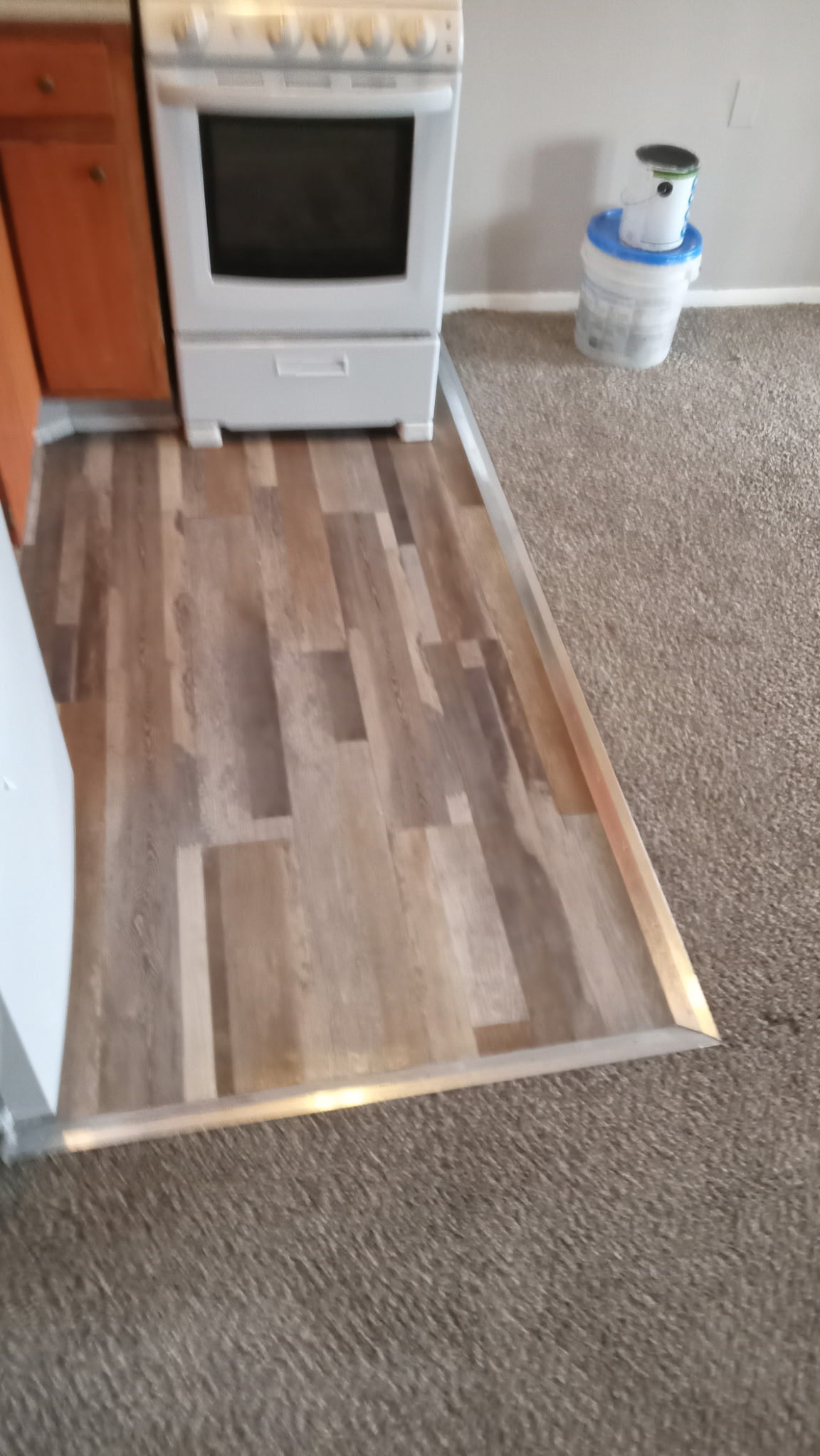 New vinyl plank flooring installed at kitchen transition after remodel